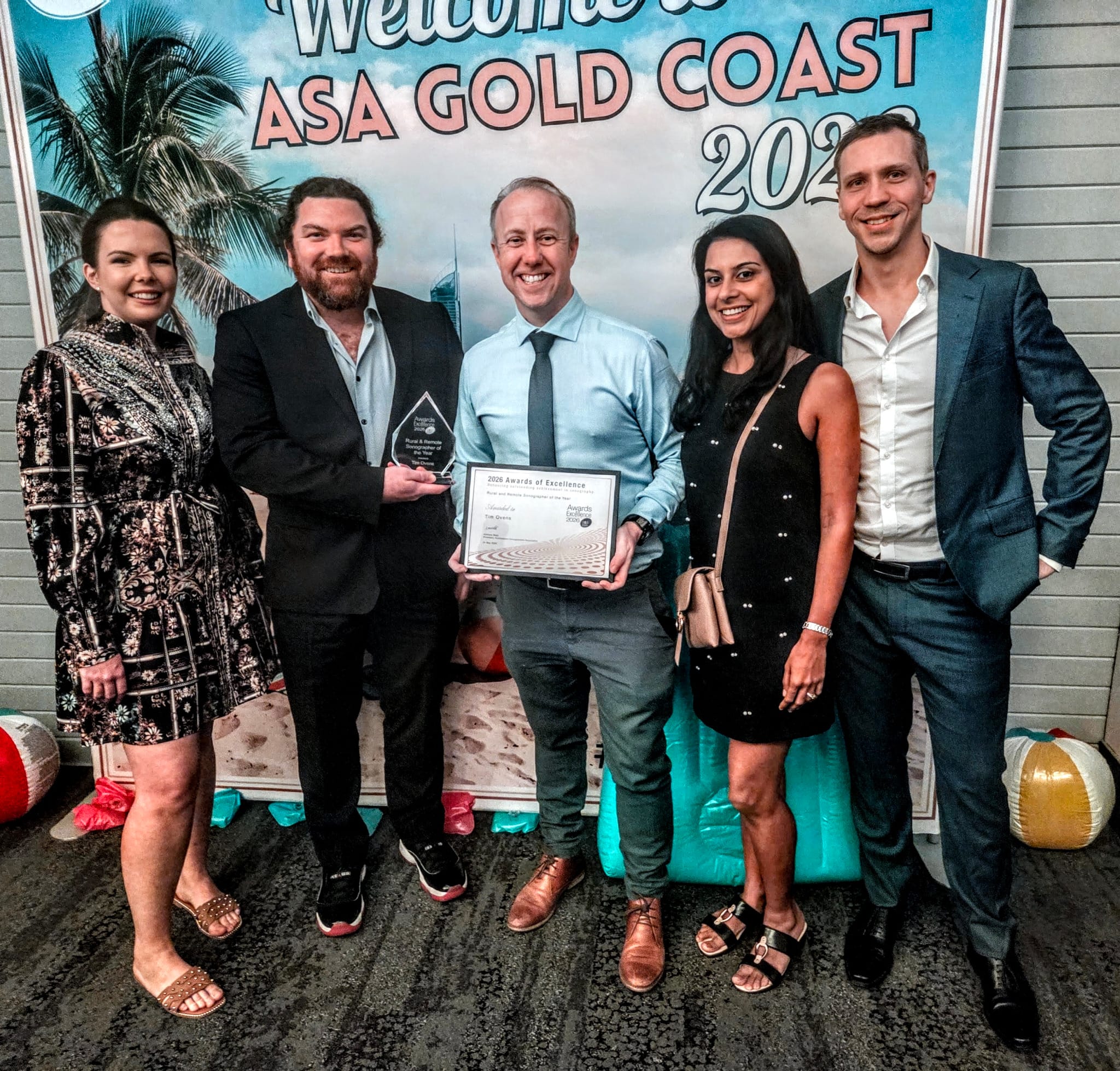 Tim Ovens with the Modia Health team, holding his ASA Rural and Remote Sonographer of the Year award